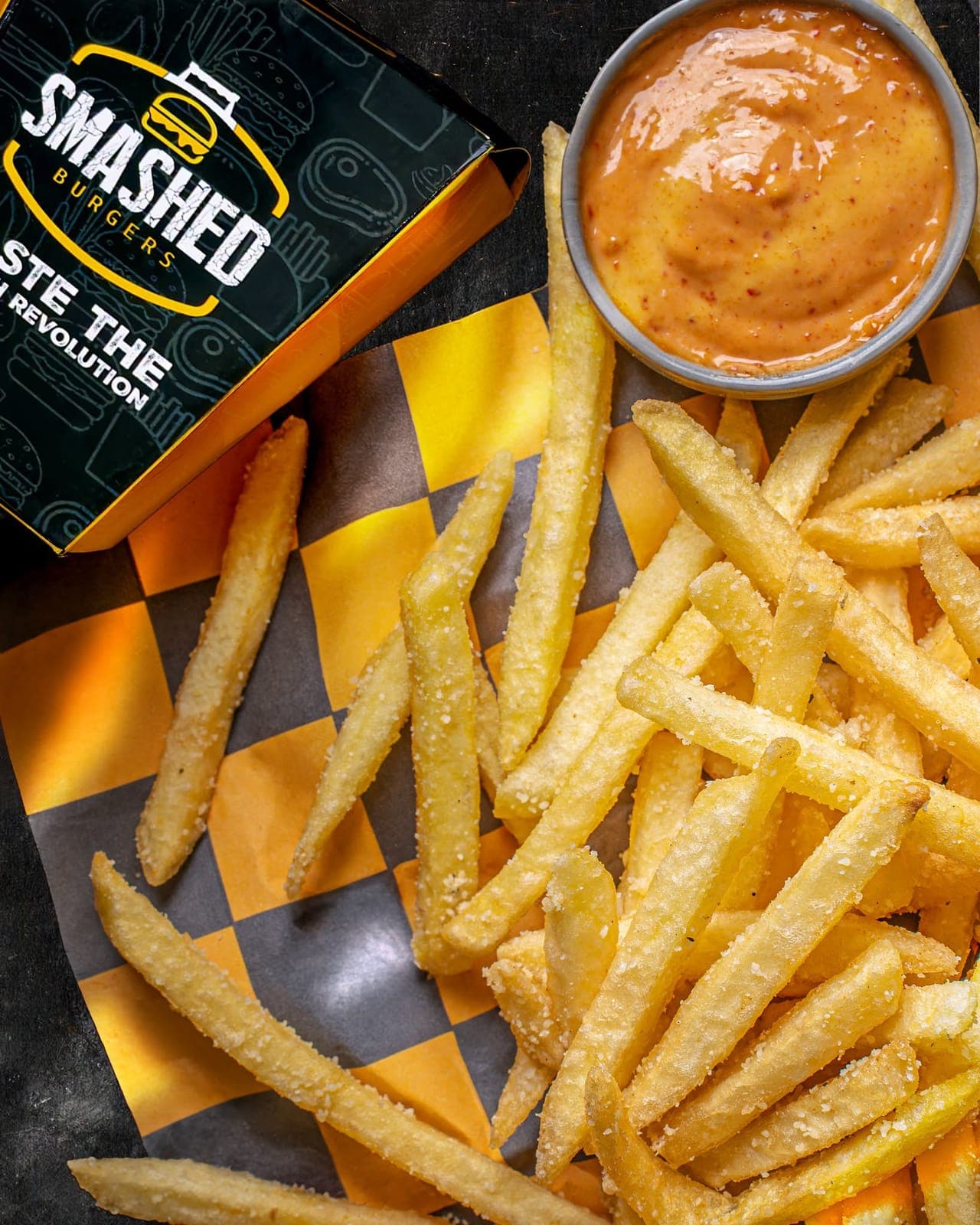 Fries and dip on checkered paper