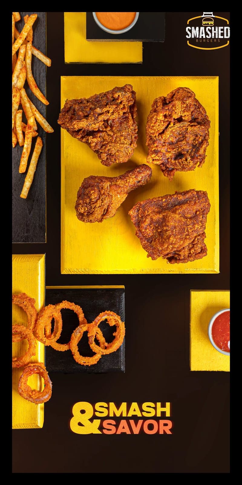 Fried chicken, onion rings and fries on yellow boards
