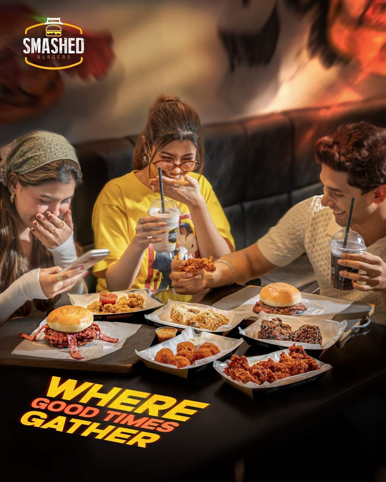 Friends sharing burgers, wings and shakes at Smashed